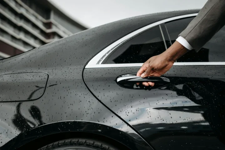 Person holding a car door handle