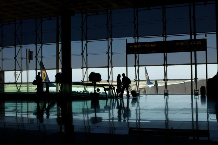 Silhouette of people walking at the airport