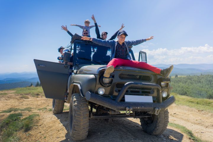 Happy family on a 4x4 truck
